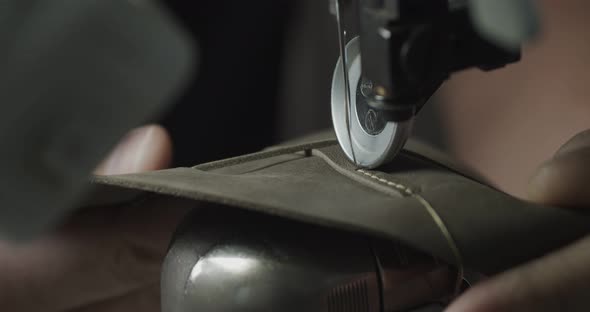 Tailor Works on Sewing Machine in Private Leather Craftshop Making Shoes in Process