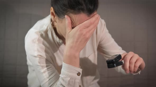 Emotional Woman with Pulseoximeter alt