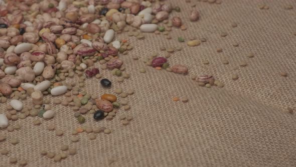 Dry legumes rotating on jute background. Beans healthy protein diet, Mediterranean vegan vegetarian alt