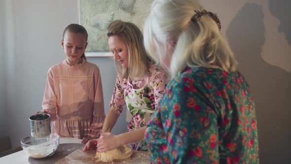 All Women in Family Participate in Baking Process on Home Kitchen alt