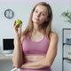 Portrait of Beautiful Young Woman Holding Apple and Smiling Standing in Apartment - VideoHive Item for Sale