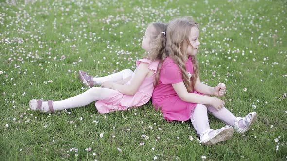 Two Lovely Little Girls in Pink Smiling at Camera