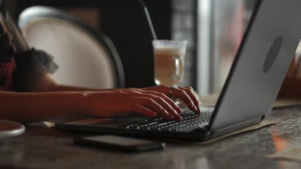 Closeup of Business Woman Hand Typing on Laptop Keyboard. Closeup of a Female Hands Busy Typing on a alt