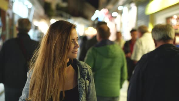 Female Traveler on Crowded Street of Greek Athens Looking at Shops Glass Cases alt