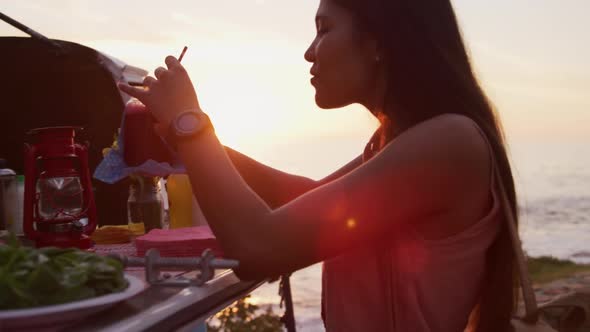 Young woman drinking a smoothie from food truck alt