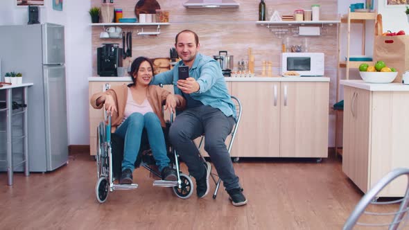 Positive Woman in Wheelchair and Husband Taking a Selfie alt