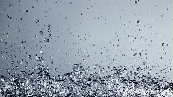 Splashes of Water Rise Up and Rotate in Flight alt