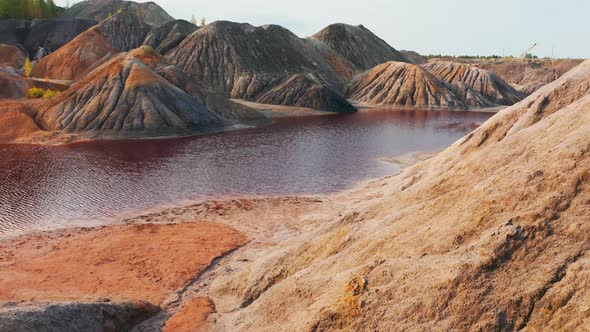 Aerial View of a Landscape Similar To the Planet Mars with Red Hills and Rivers with Red Water alt