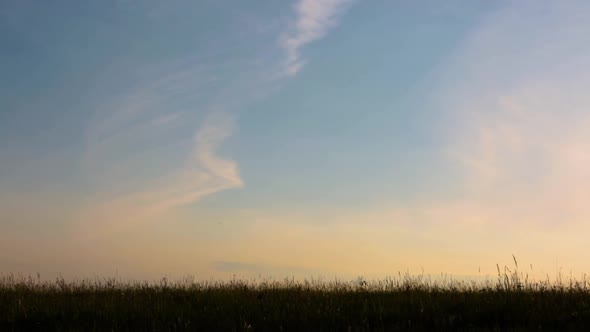 Silhouette of Boy at Sunset. The Boy Runs From One Side To the Other on a Summer Evening. alt