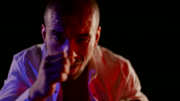 Closeup Portrait of Aggressive Drunk Man Punching to Camera Slow Motion Shot alt