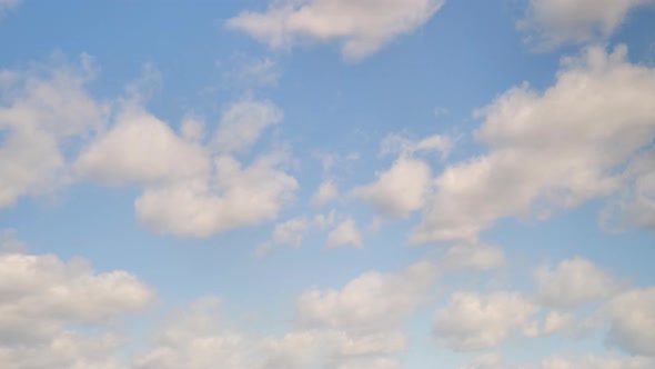 White cumulus clouds in the blue sky, timelapse. Bright beautiful sky, copy space background
