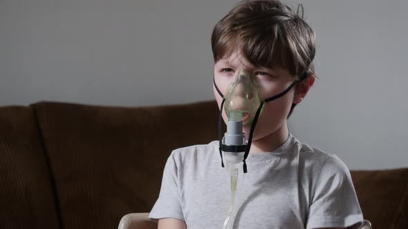 Sick Boy Breathing while Using Nebulizer and Coughing During COVID-19 Pandemic