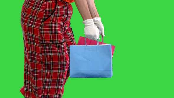 Hands of Walking Clown with Shopping Bags on a Green Screen Chroma Key alt