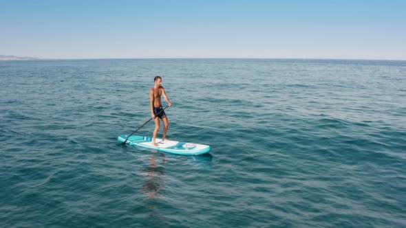Man Navigate On Sup Board alt
