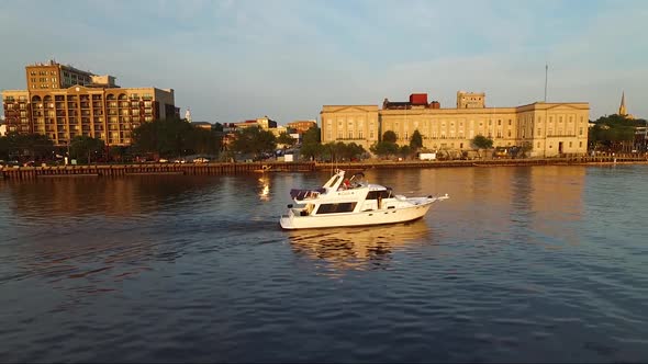 Tracking a boat on the Cape Fear River close to downtown Wilmington NC and the battleship at sunset alt