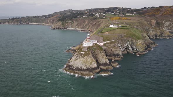 Baily Lighthouse At Howth Head, Dublin Bay Ireland - aerial drone shot alt