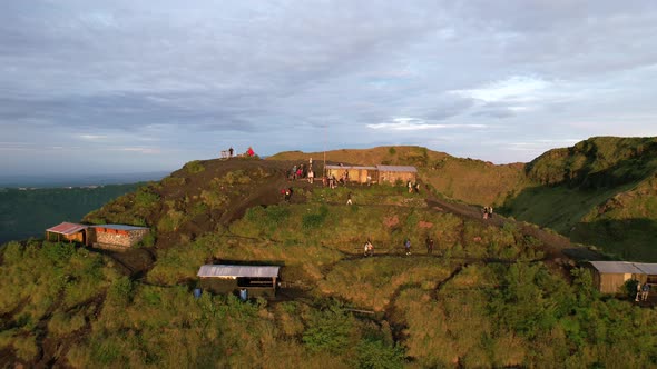 aerial dolly zoom out of coffee huts on a volcano rim in Bali Indonesia alt