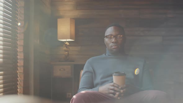 Portrait of Afro-American Man Sitting with Coffee Cup alt