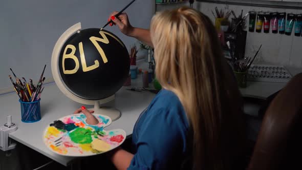 Overweight Woman Painting BLM Sign on the Black Globe alt