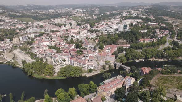 Panoramic view of Amarante by idyllic Tamega river, Minho, Portugal. Aerial pullback alt