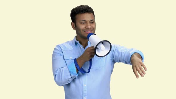 Man Talking Into Megaphone and Gesticulating with Hand. alt