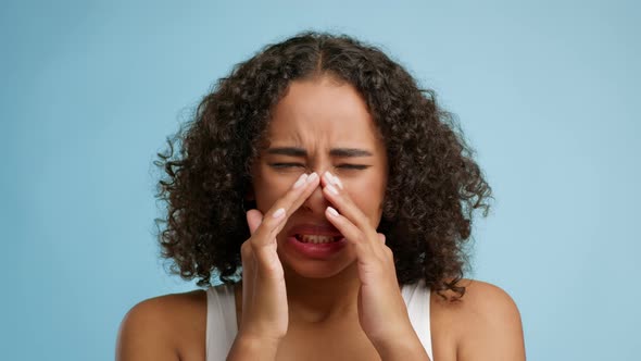 Sick Black Lady Touching Sore Nose Over Blue Background alt