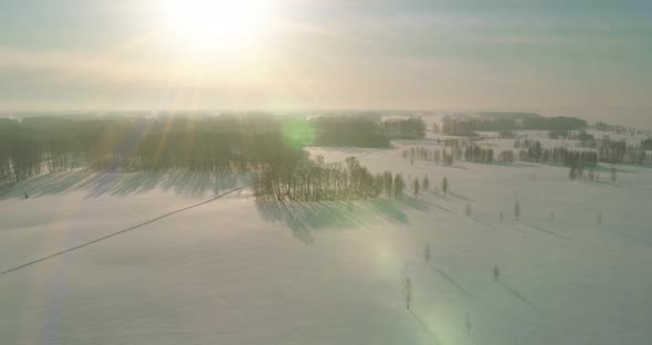 Aerial View of Cold Winter Landscape Arctic Field Trees Covered with Frost Snow Ice River and Sun alt