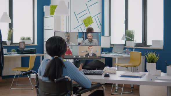 Disabled Black Manager Discussing with Remote Team Using Videocall alt