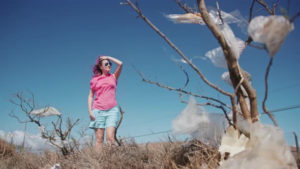 Slow Motion Modern Woman Standing on Garbage Dump on Windy Summer Day  Hawaii alt