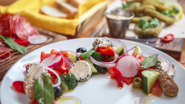 Greek salad served on table in Mediterranean restaurant for lunch alt