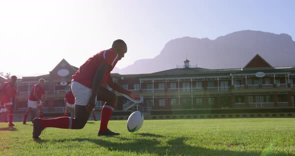 Male rugby player placing rugby ball on kicking tee in stadium 4k