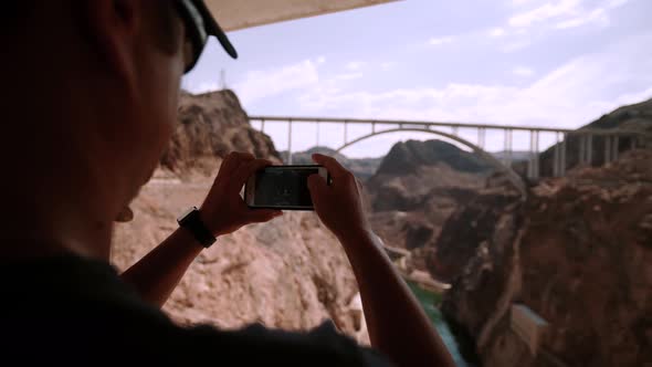 Beautiful Man Stand Using Cellphone Take Photo Hoover Dam Arizona USA. alt