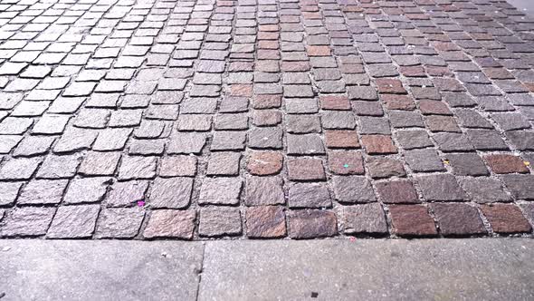 Grey Pavement with Terracotta Elements Reflecting Sunlight alt