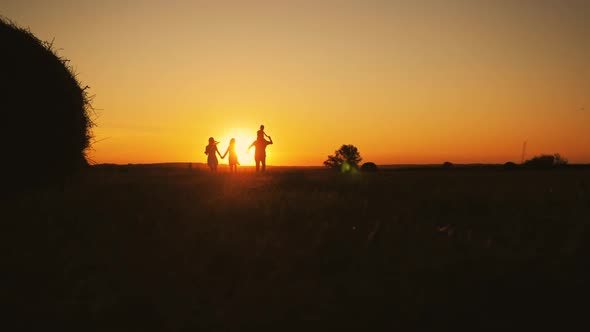 Family Silhouette with Sunset alt