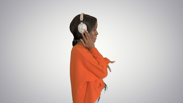 Happy african woman wear wireless headphones listening alt