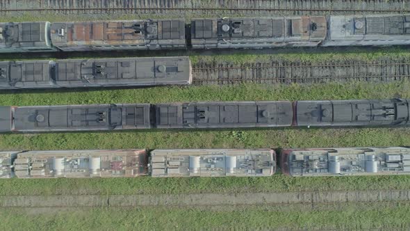 Aerial Top Down Shot of an Abandoned Rusty Locomotives and Old Railways alt