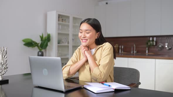 Happy Asian Female Student Making Video Call to Distant Friends
