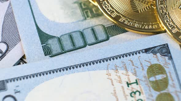 Close Up of Metal Shiny Bitcoin Crypto Currency Coin on US Dollar Bills alt