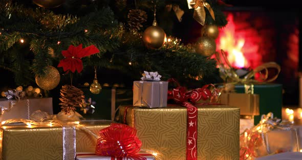 Christmas Gifts near Christmas Tree and Fireplace