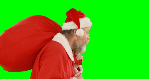 Santa claus with finger on lips carrying sack 4k alt