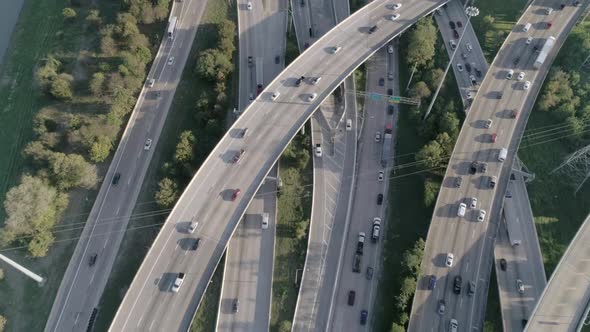 This video is of an aerial of heavy traffic on freeway in major city. This video was filmed in 4k fo alt