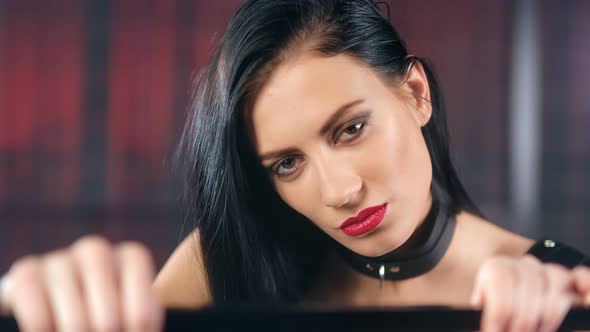 Face of Beautiful Lust Female in Latex and Leather Collar Having Debauchery Emotion alt