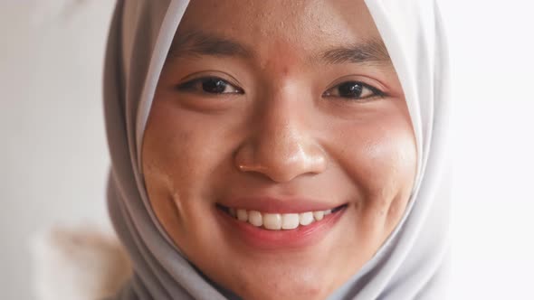 Portrait of Happy Muslim Young Woman Smiling to Camera Wearing Hijab