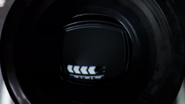 Retro camera close. Board clapper in reflection. Cinematography movie directing.