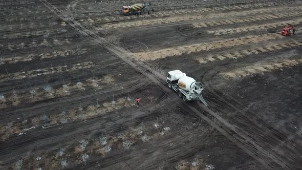High Angle View of a Field with Lots of People and Trucks Solar Power Station alt