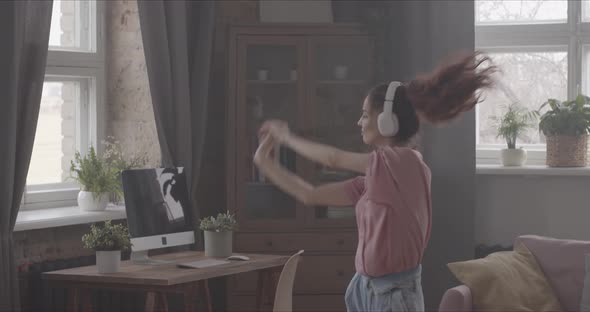 Girl Dancing With Headphones On Her Head