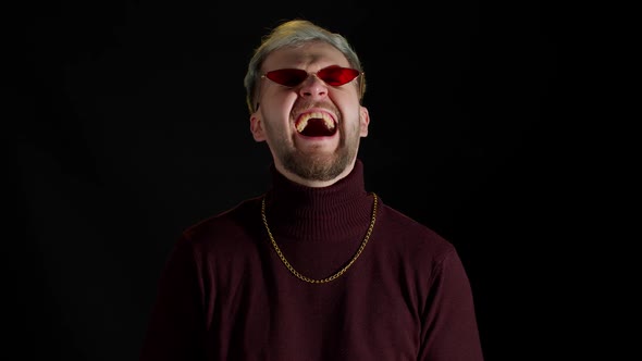 Stylish Smiling Young Man in Red Sunglasses Looking at Camera Laughting at Loud Feeling Happiness alt