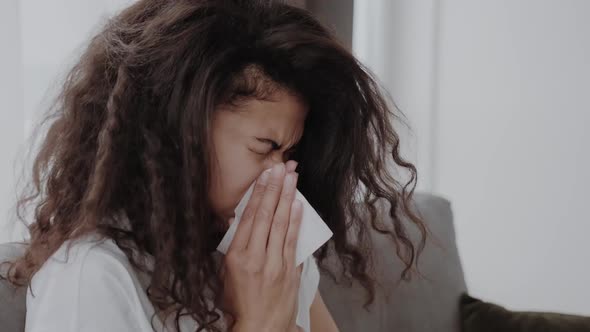 AfricanAmerican Woman Got Sick Caught a Cold Has a Flu Sits at Home on the Couch and Sneezes She alt
