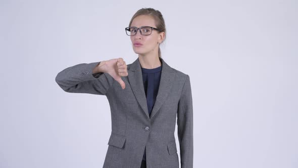 Young Serious Businesswoman Giving Thumbs Down alt