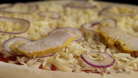 The Hand Is Putting Chicken Meat on Pizza Closeup